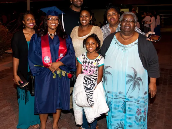 A family poses for a photo after graduation